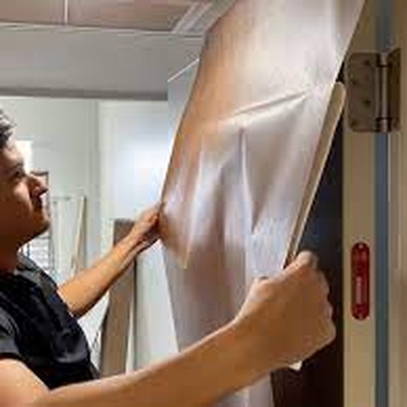 3M DI-NOC Architectural Film – Hotel Door Resurfacing 3M DI-NOC architectural film applied to hotel guest room doors, giving a premium wood finish and durable protection.