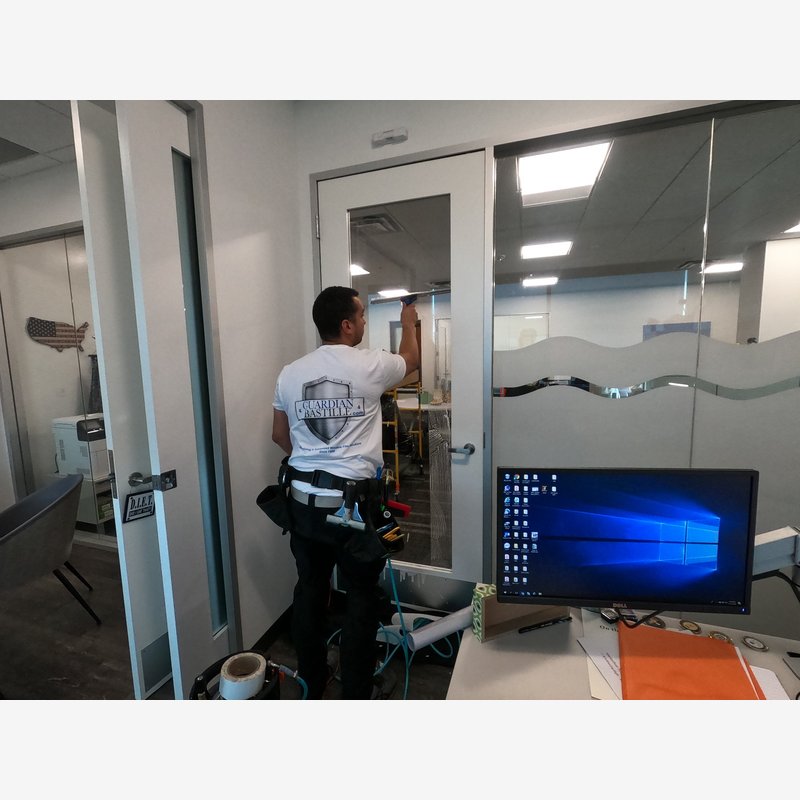 Conference Room Frosted Window Film Installation Frosted decorative window film installed on glass conference room walls by Guardian Bastille to enhance privacy while maintaining light and openness.