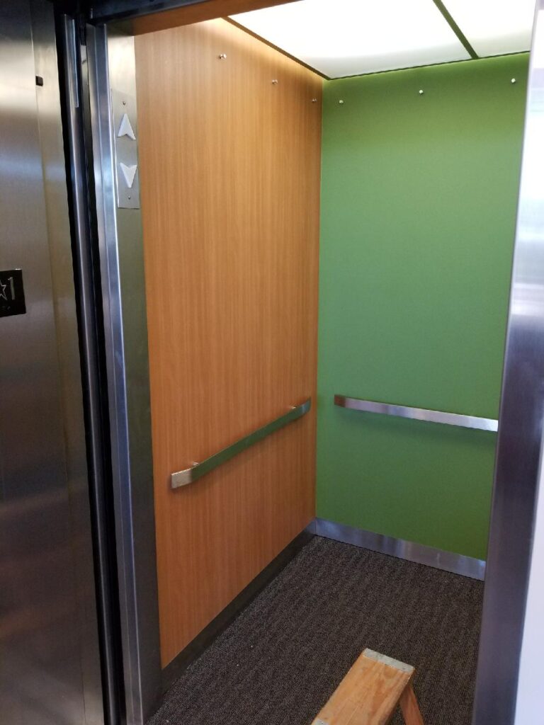 3M DI-NOC Architectural Film – Elevator Renovation and Resurfacing 3M DI-NOC architectural film applied to elevator doors and panels, providing a modern, durable finish for high-traffic areas.