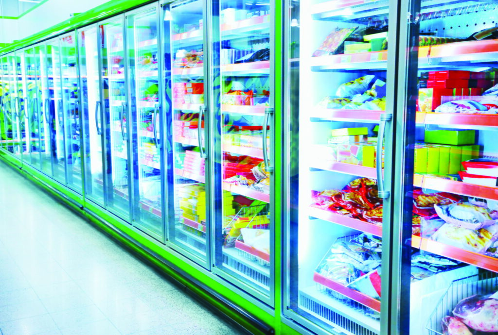 Anti-Fog Window Film for Refrigerated Display Cases Anti-fog window film preventing condensation on glass refrigeration doors in a grocery store display.