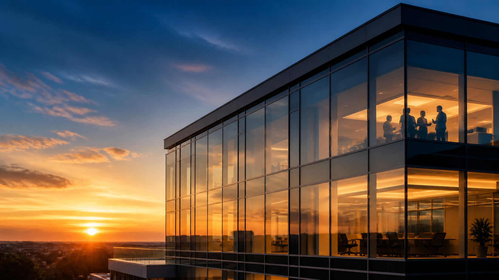 Modern commercial glass building at sunset representing Guardian Bastille commercial window film solutions