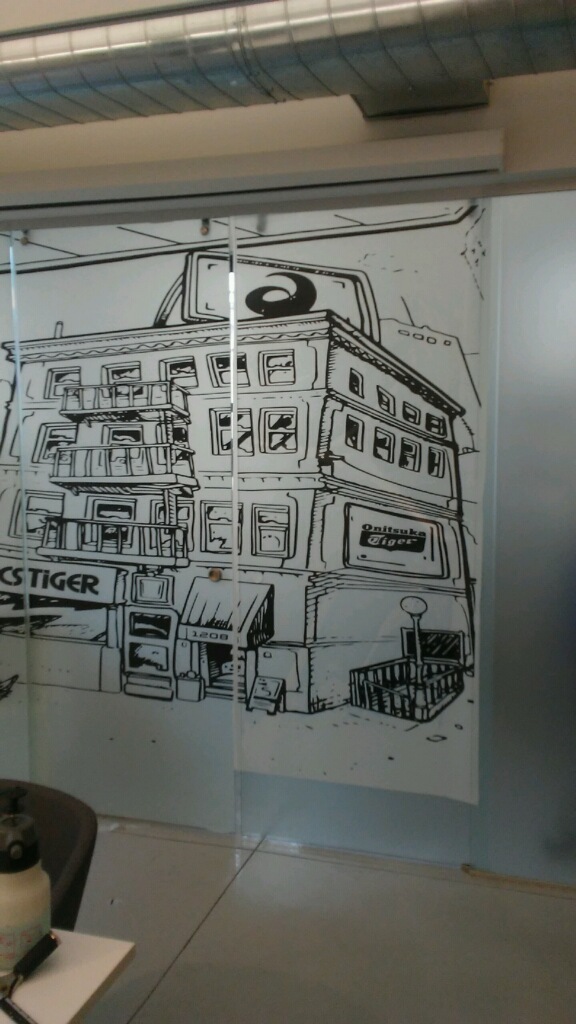 Custom printed ASICS graphic coming off the large-format printer
